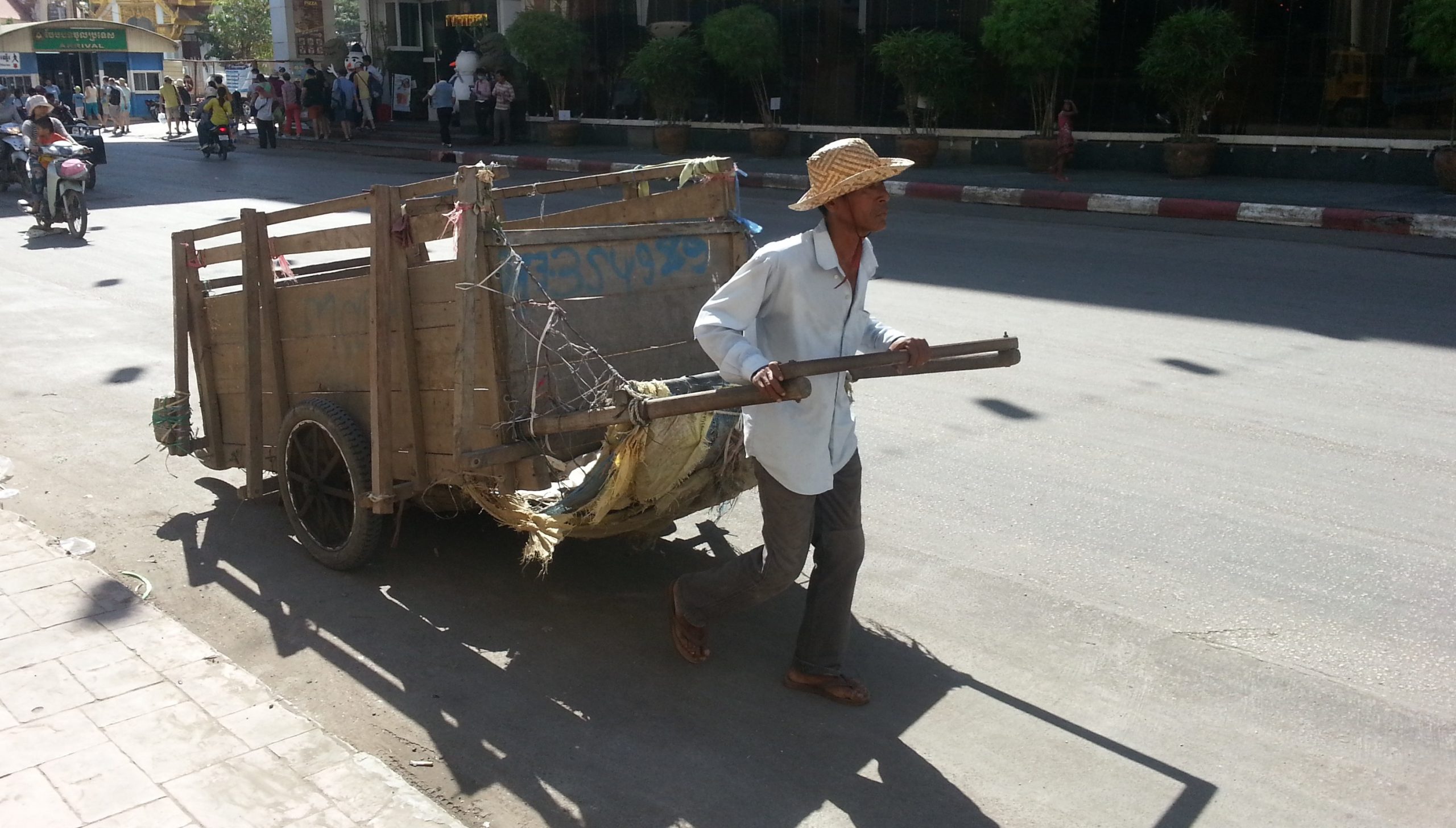 Cambodia Man Pulling Rubbish Cart On Hot Street Scaled 1